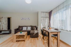a living room with a couch and a table at Katerina Apartments 2 in Velingrad