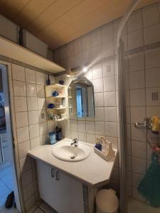 a bathroom with a sink and a mirror at FeWo Westwind in Fehmarn +12 photos
