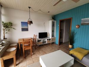 a living room with a table and a dining room at FeWo Westwind in Fehmarn