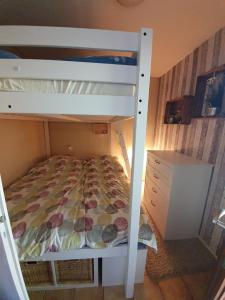 a bunk bed in a small room with a bed gmaxwell gmaxwell gmaxwell at FeWo Westwind in Fehmarn