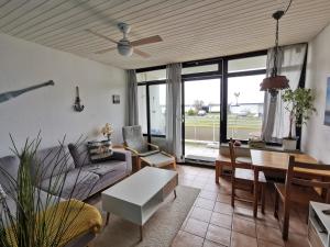 a living room with a couch and a table at FeWo Westwind in Fehmarn