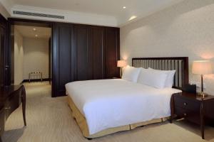 Letto o letti in una camera di Evergreen Laurel Hotel, Shanghai