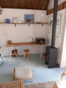 a room with a desk and a wood stove at TIJ Tiny house aan het getijdewater in Zierikzee in Zierikzee