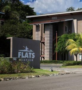 a sign for a flats institute in front of a building at Condo Playa Hermosa, Puntarenas in Muñeco