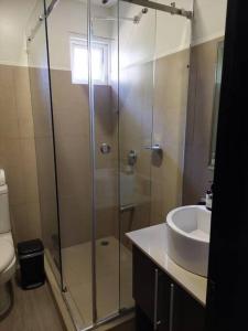 a bathroom with a shower and a sink at Condo Playa Hermosa, Puntarenas in Muñeco