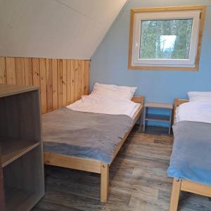 a bedroom with two beds and a window at Stanica Wodna Płaska in Płaska +21 photos