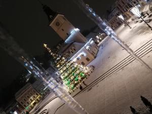 a city at night with christmas lights in front of a building at 4 Rooms Piata Sfatului in Braşov