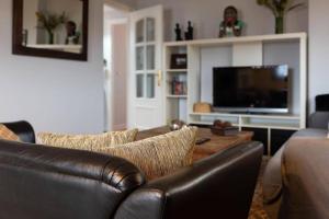 Televízia a/alebo spoločenská miestnosť v ubytovaní Anduriña16 by VigoVacaciones