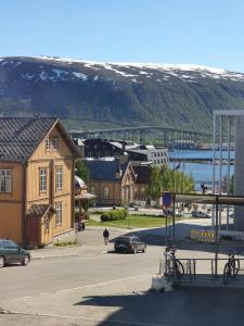 a view of a town with a bridge in the background at Small and cute apartment in city center in Tromsø