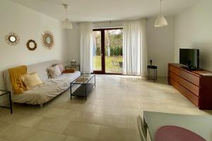 a living room with a couch and a tv at Bursztynowa 16 Hel in Hel