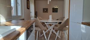 a kitchen with a table and chairs in a room at Holiday home Paula in Radovići