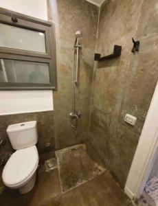 a small bathroom with a toilet and a shower at Gouna 1 Bedroom Villa Private Pool & Patio Up to 5 Persons Bali in Hurghada