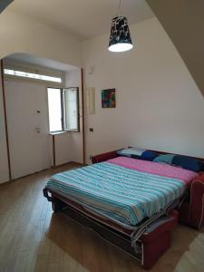 a bedroom with a large bed in a room at Casa vacanze Maison Zio Bruno A' Scalinatella in Naples