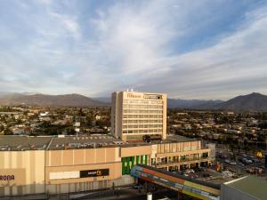 a building with a train in front of a city at Hotel Terrado Rancagua in Rancagua