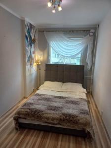 Säng eller sängar i ett rum på Apartament M-5