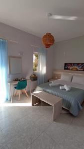 a bedroom with a bed and a table and a desk at Aloni Studios and Apartments in Lassi