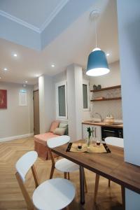 a kitchen and living room with a table and chairs at Patio Apartment near metro & Acropolis in Athens