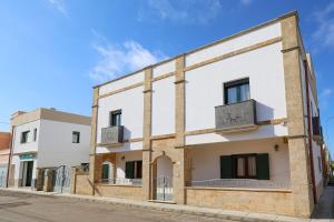 an old building with a clock on the side of it at Il Sole Del Salento in Salve