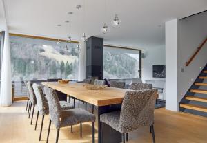 a dining room with a wooden table and chairs at Design Villa M in Gortipohl