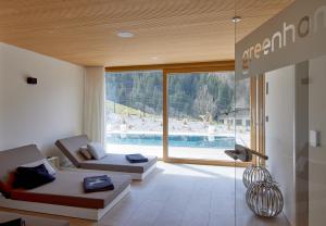 a living room with a view of a swimming pool at Design Villa M in Gortipohl