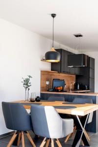 a kitchen with a wooden table and some chairs at Living797 in Albstadt