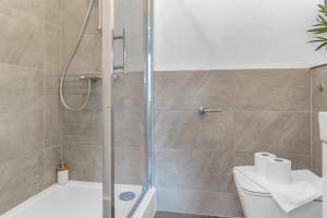 een badkamer met een douche en een toilet bij Cheerful Stays - Jamson Pl 3 Bed Apartment in Edinburgh