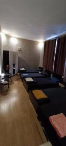 a room with a bunch of beds lined up at Best private rooms In the center in Sofia