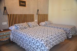 a bedroom with two beds and a table at AniCa II, el lugar de la Mancha in Argamasilla de Alba +71 photos
