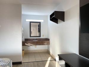 a bathroom with a sink and a mirror at Studio 6 Stockbridge GA Hwy 138 W in Stockbridge