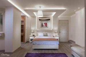 a bedroom with a bed and two tables and a couch at شقه فندقيه in Alexandria