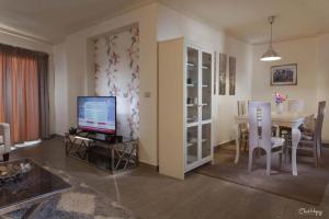 a living room with a table with a television and a dining room at شقه فندقيه in Alexandria