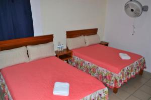 Postel nebo postele na pokoji v ubytování Orquídeas Hotel
