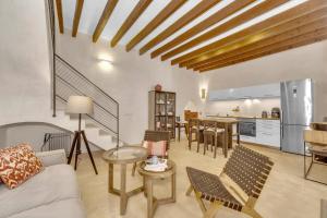 Il comprend un salon avec un canapé et une cuisine. dans l'établissement charmantes und modernes Stadthaus Casa Corazon, à Santanyí