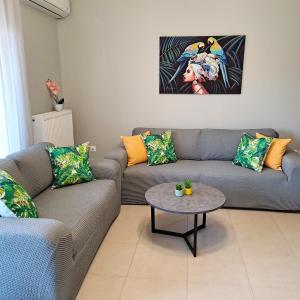 a living room with two couches and a table at Lefkada CP Residences in Lefkada Town