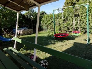 a yard with two swings and a swing at Rigó Vendégház in Siófok