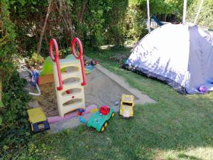 a childs play area with a sandbox and a tent at Rigó Vendégház in Siófok