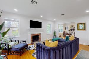 a living room with a couch and a fireplace at Northwood Charmer in West Palm Beach