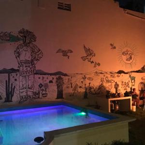 a mural in a room with a swimming pool at Venado 28 in Cancún