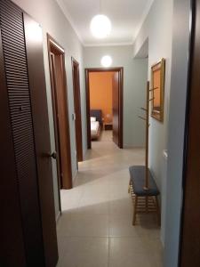 a hallway with a room with a bed and a chair at Lefkada CP Residences in Lefkada Town