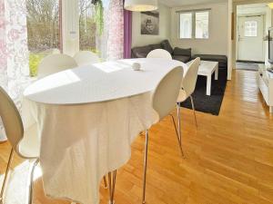 Biały stół i krzesła w salonie w obiekcie Holiday home RAA HELSINGBORG w mieście Pålstorp