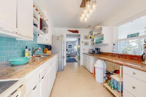 a kitchen with white cabinets and a sink and a window at Town of South Bethany --- 5 Surfside St in Bethany Beach