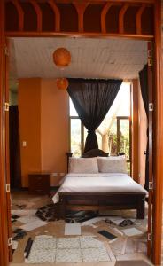 - une chambre avec un lit et une grande fenêtre dans l'établissement Hotel Campestre Villa Los Duraznos, à Paipa
