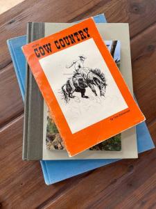 two books sitting on top of a table at Grand Canyon Hideaway Tiny home in Valle