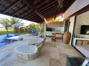 an outdoor patio with a pool and a table and chairs at Bangalô Porto Galinhas in Porto De Galinhas