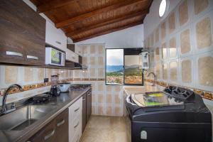 a kitchen with a sink and a counter top at Espectacular casa cerca a parques turisticos in Medellín