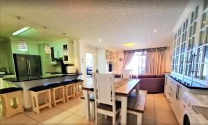 a kitchen with a table and chairs in a room at Santorini Unit RR in Margate