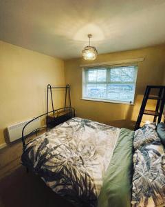 a bedroom with a bed and a window at Two Double bedrooms apartment near Hull city centre in Hull