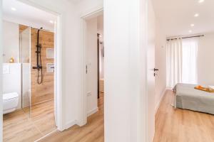 a bathroom with a shower and a bed in a room at Kuća za odmor INK in Nerežišće +46 photos