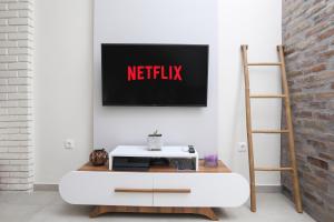 a living room with a netflix sign on a wall at ΒeΙΙa Kanoni Corfu in Kanoni