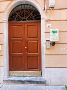 a wooden door on a building with an arch at COVO DI LEVANTE in La Spezia
